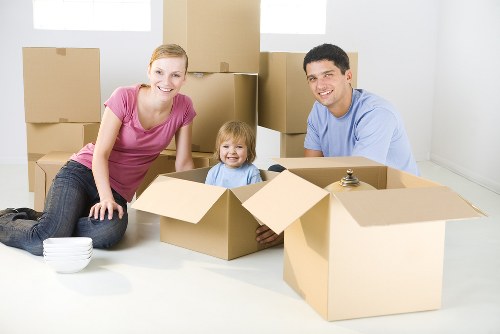 House removalists loading furniture in a Richmond street with terrace homes