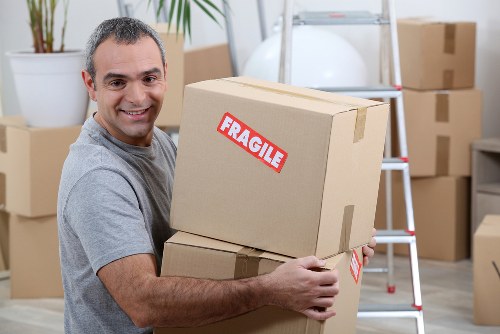 Student removals team handling boxes in Richmond near residential flats