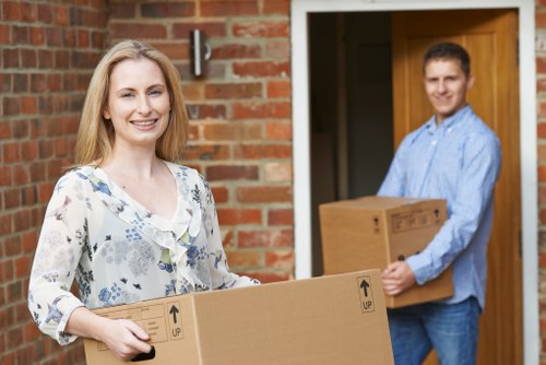 Local removals team carrying furniture from a Richmond property