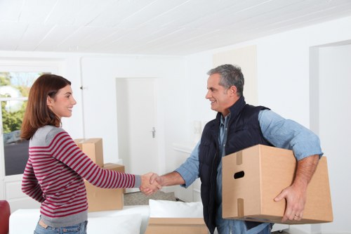 Professional movers handling furniture carefully as part of insured man and van service